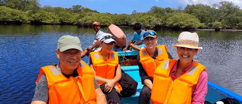 Family off our wearing life jackets on a boat tour through the mangroves of juan venado nature reserve in Nicaragua